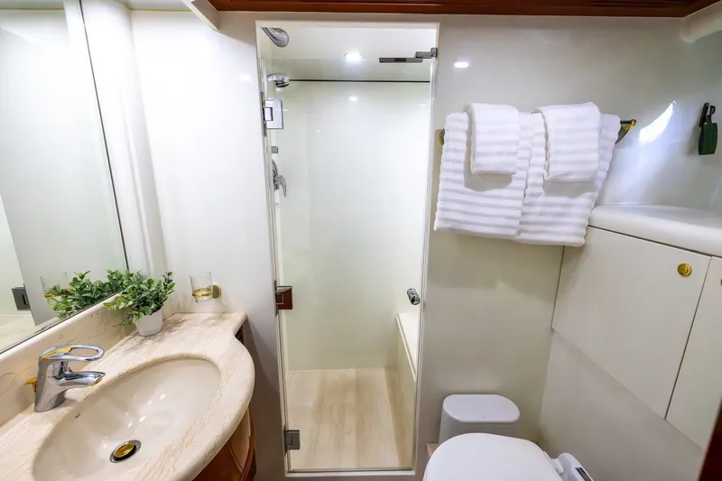 Slide: The Image of Luxurious bathroom in 2003 Johnson 87' Motor Yacht with modern fixtures and elegant design. - 47