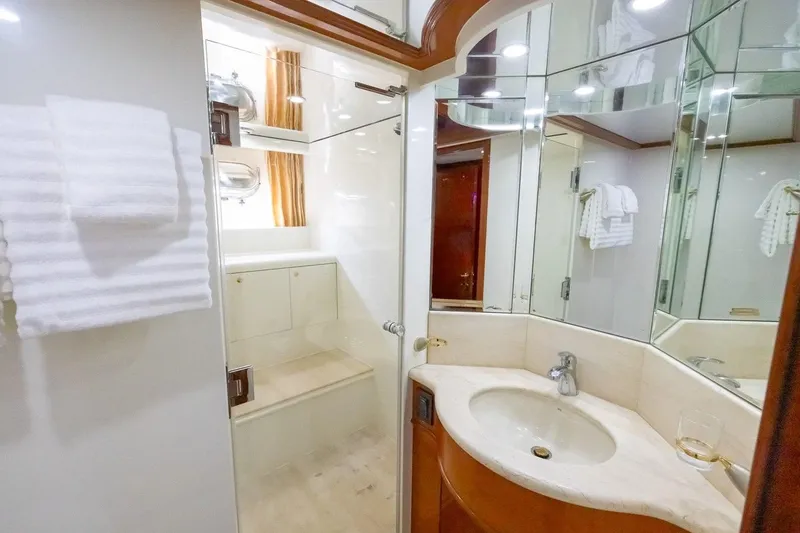 Slide: The Image of Luxurious bathroom in 2003 Johnson 87' Motor Yacht with elegant fixtures and mirrored walls. - 48