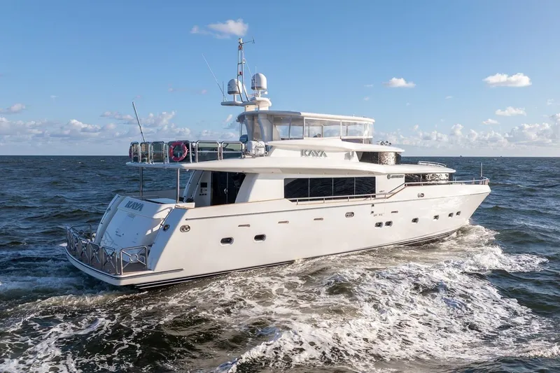 Slide: The Image of Luxury 2003 Johnson 87' Motor Yacht cruising on open sea under clear skies. - 5