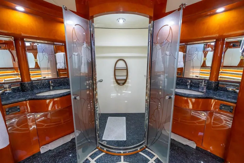 Slide: The Image of Luxurious bathroom on 2003 Johnson 87' Motor Yacht with elegant wood and glass design. - 55