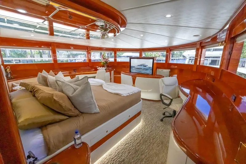 Slide: The Image of Luxurious interior of 2003 Johnson 87' Motor Yacht with elegant wood finishes and plush bedding. - 57