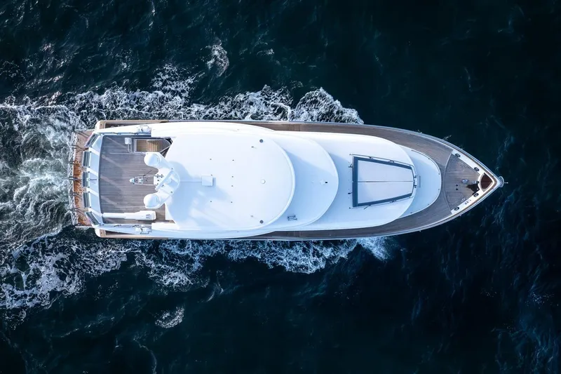 Slide: The Image of Top view of 2003 Johnson 87' Motor Yacht cruising on open water. - 6