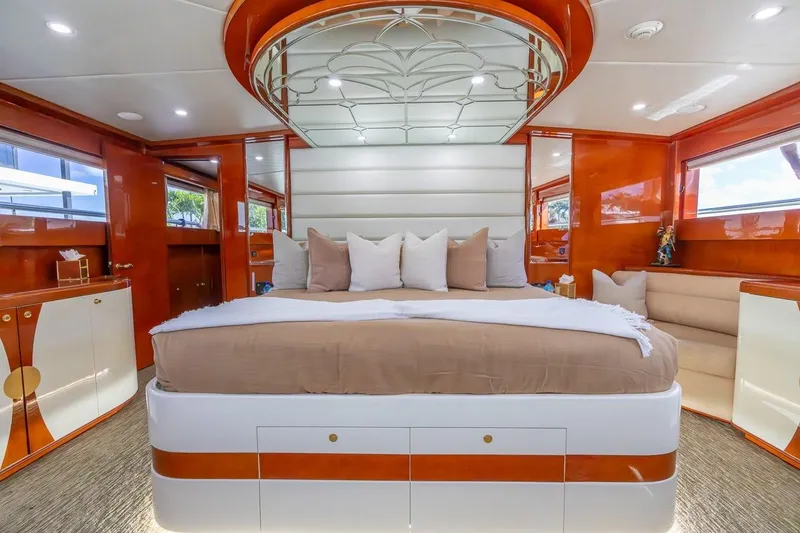 Slide: The Image of Luxurious bedroom interior of 2003 Johnson 87' Motor Yacht with elegant wood finishes and plush bedding. - 61