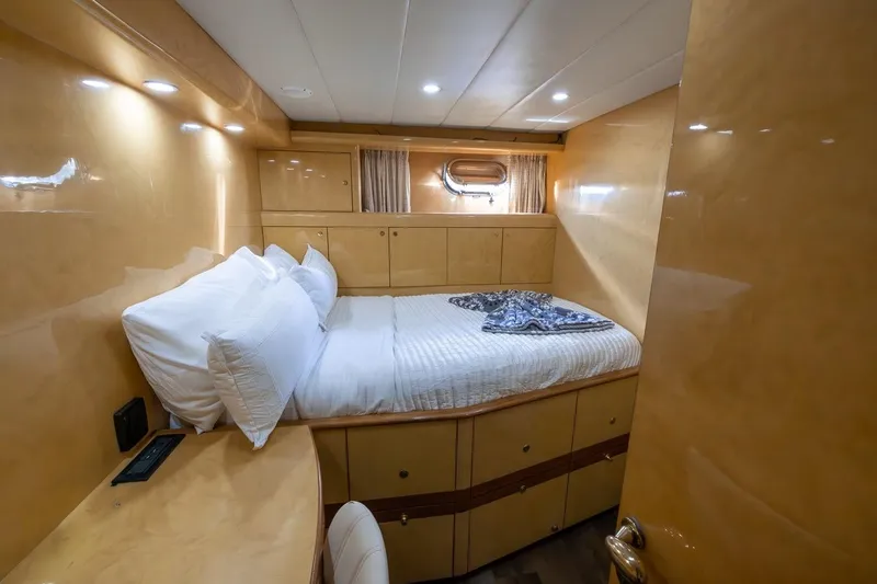 Slide: The Image of Luxurious bedroom interior of 2003 Johnson 87' Motor Yacht with cozy bed and wooden finish. - 62