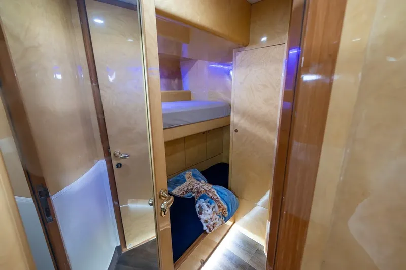 Slide: The Image of Interior of 2003 Johnson 87' Motor Yacht with cozy bunk beds and wooden finish. - 65