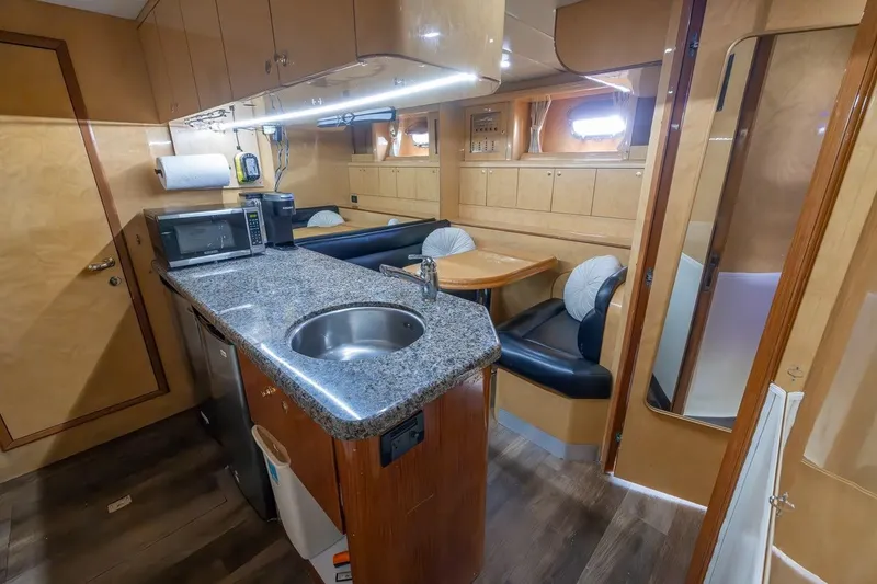 Slide: The Image of Luxurious 2003 Johnson 87' Motor Yacht interior with modern kitchen and dining area. - 66