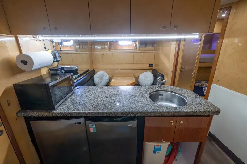 Slide: The Image of Luxurious kitchen area in a 2003 Johnson 87' Motor Yacht with granite countertop. - 67