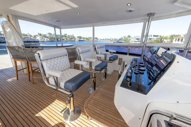 Slide: The Image of Luxurious 2003 Johnson 87' Motor Yacht helm with plush seating and panoramic views. - 69
