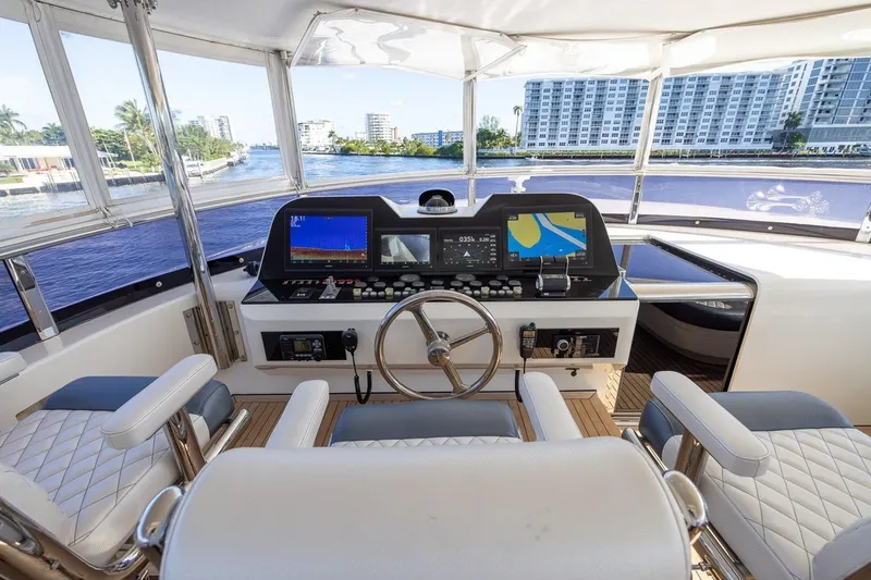 Slide: The Image of Luxurious helm of 2003 Johnson 87' Motor Yacht with modern navigation equipment. - 71