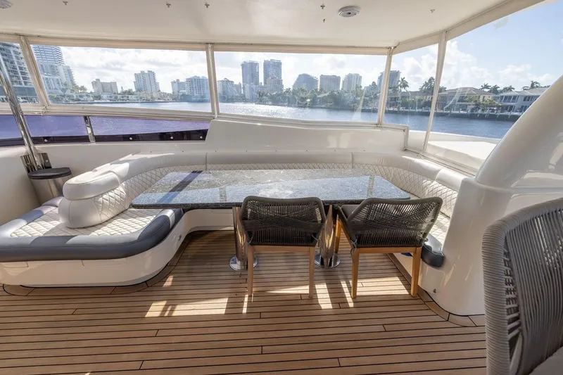 Slide: The Image of Luxurious 2003 Johnson 87' Motor Yacht interior with elegant seating and waterfront view. - 72