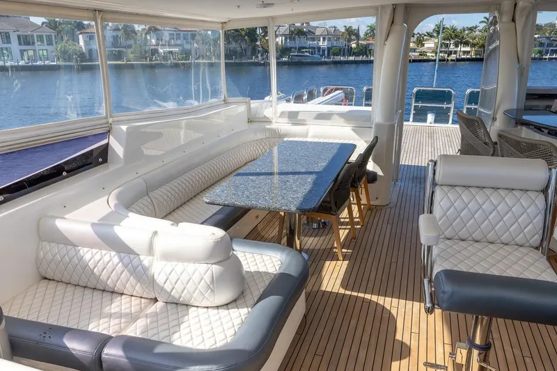 Slide: The Image of Luxurious interior of 2003 Johnson 87' Motor Yacht with elegant seating and waterfront view. - 75