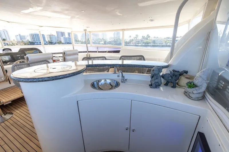Slide: The Image of Luxurious 2003 Johnson 87' Motor Yacht with elegant outdoor bar and scenic city views. - 76