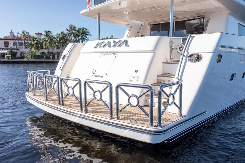 Slide: The Image of Luxury 2003 Johnson 87' Motor Yacht docked, featuring sleek design and spacious deck. - 8