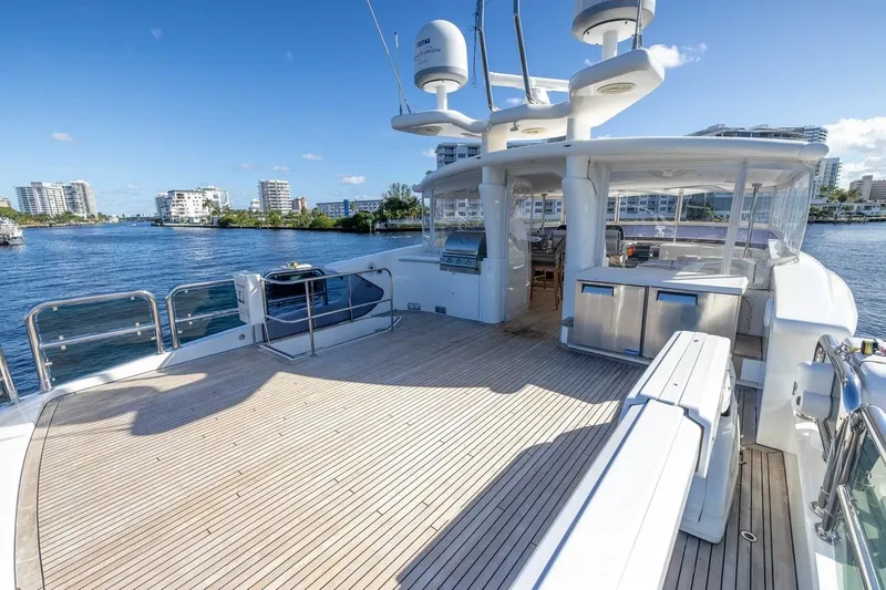 Slide: The Image of Luxurious 2003 Johnson 87' Motor Yacht deck with scenic waterfront view. - 81