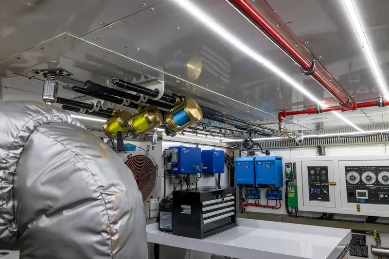 Slide: The Image of Engine room of 2003 Johnson 87' Motor Yacht with control panels and equipment. - 85