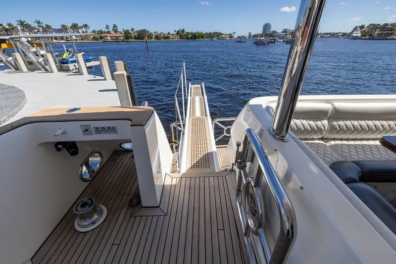 Slide: The Image of Luxurious 2003 Johnson 87' Motor Yacht docked by scenic waterfront. - 86