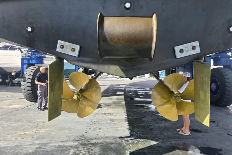 Slide: The Image of Propellers of a 2003 Johnson 87' Motor Yacht in a shipyard. - 89
