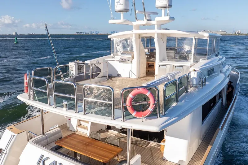 Slide: The Image of Luxurious 2003 Johnson 87' Motor Yacht cruising on open water, featuring spacious deck and modern amenities. - 9