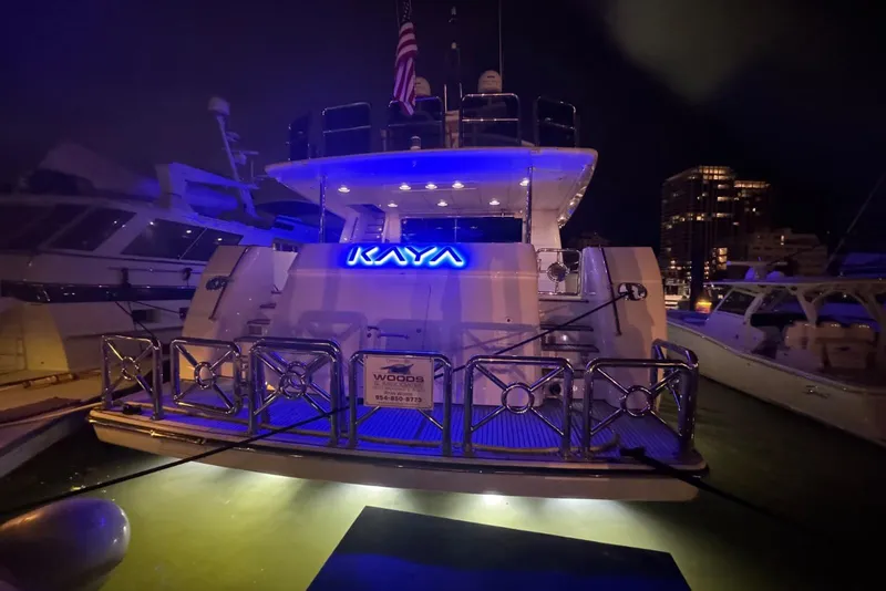 Slide: The Image of Luxurious 2003 Johnson 87' Motor Yacht docked at night with illuminated name "Kaya". - 91