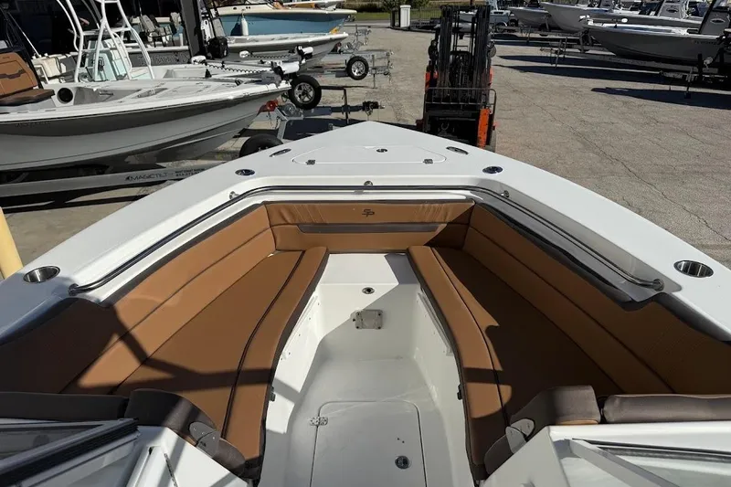 Slide: The Image of 2026 Sea Pro 240 Dual Console boat with tan seating, docked in a marina. - 15