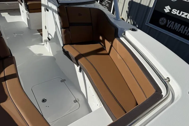 Slide: The Image of 2026 Sea Pro 240 Dual Console boat interior with brown cushioned seating. - 17