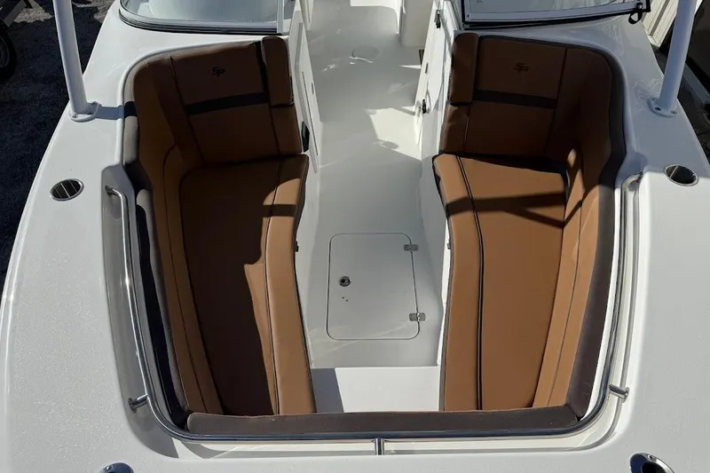 Slide: The Image of 2026 Sea Pro 240 Dual Console boat interior with brown seating and white deck. - 18