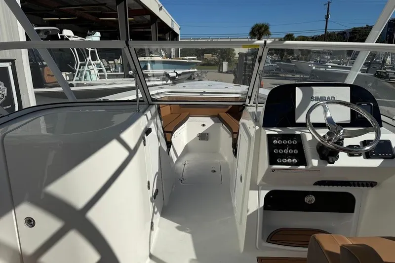 Slide: The Image of 2026 Sea Pro 240 Dual Console boat interior with steering wheel and control panel. - 24