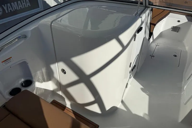 Slide: The Image of 2026 Sea Pro 240 Dual Console interior with seating and storage compartments. - 25