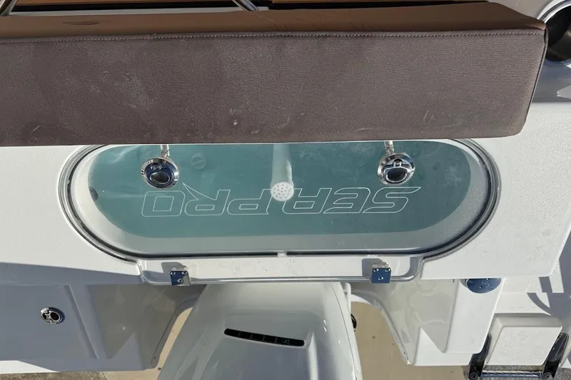 Slide: The Image of 2026 Sea Pro 240 Dual Console boat with visible livewell and seating area. - 29