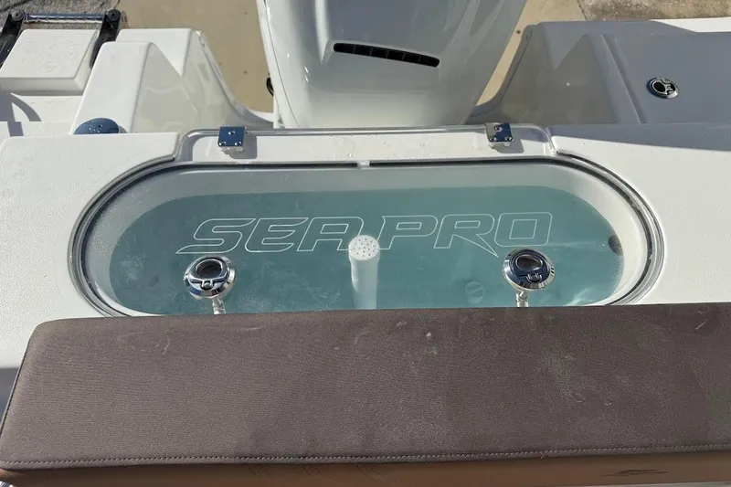 Slide: The Image of 2026 Sea Pro 240 Dual Console boat livewell with logo, featuring sleek design and functionality. - 30