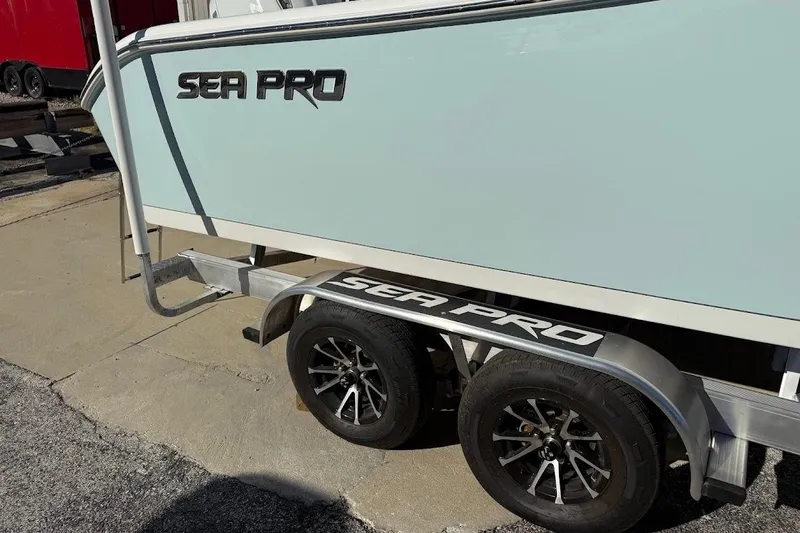 Slide: The Image of 2026 Sea Pro 240 Dual Console boat on trailer, showcasing sleek design and branding. - 6