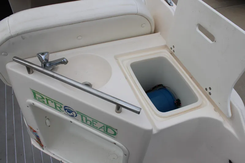 Slide: The Image of 2002 Rinker Fiesta Vee 250 boat sink and storage compartment detail. - 11