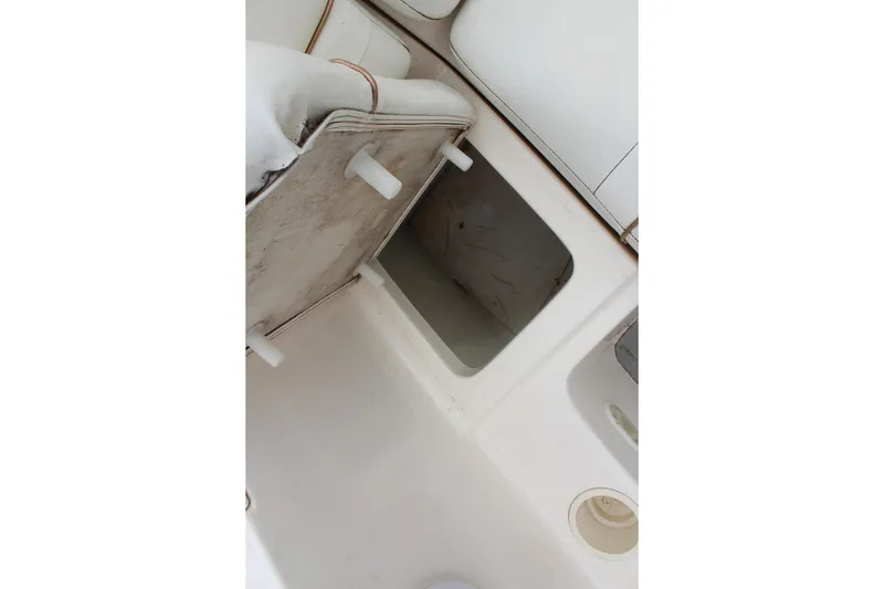 Slide: The Image of 2002 Rinker Fiesta Vee 250 boat interior storage compartment and seating area. - 16