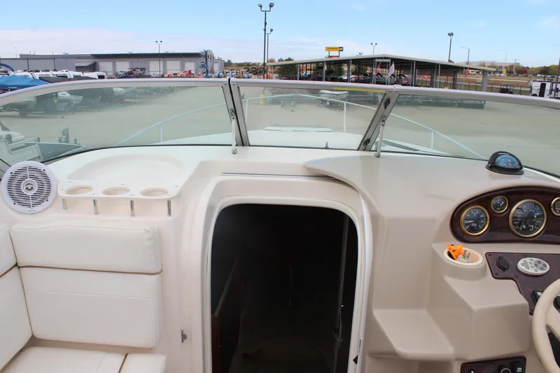 Slide: The Image of 2002 Rinker Fiesta Vee 250 boat interior with dashboard and seating area. - 18