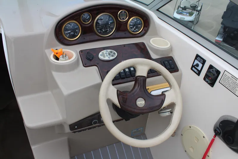 Slide: The Image of 2002 Rinker Fiesta Vee 250 boat dashboard with steering wheel and instrument panel. - 19
