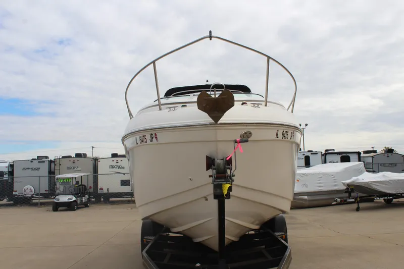 Slide: The Image of 2002 Rinker Fiesta Vee 250 boat on trailer, parked in storage lot. - 2