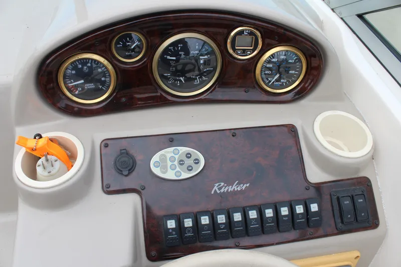 Slide: The Image of 2002 Rinker Fiesta Vee 250 dashboard with gauges and control panel. - 20