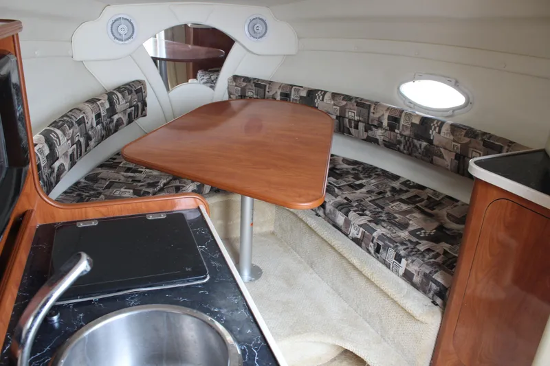 Slide: The Image of 2002 Rinker Fiesta Vee 250 cabin interior with dining area and kitchenette. - 23