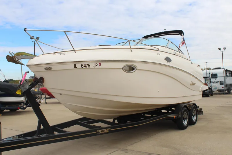 Slide: The Image of 2002 Rinker Fiesta Vee 250 boat on trailer, parked outdoors. - 3