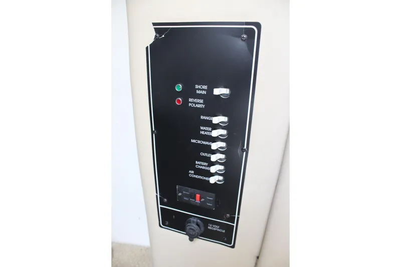 Slide: The Image of Control panel of a 2002 Rinker Fiesta Vee 250 boat with labeled switches. - 32