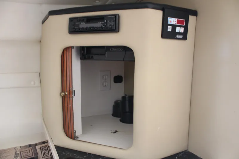 Slide: The Image of 2002 Rinker Fiesta Vee 250 cabin interior with stereo and control panel. - 33