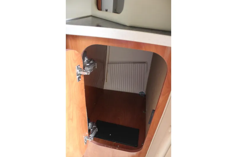 Slide: The Image of Open wooden cabinet inside 2002 Rinker Fiesta Vee 250 boat interior. - 35