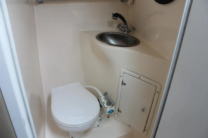 Slide: The Image of 2002 Rinker Fiesta Vee 250 boat bathroom with toilet and sink. - 36