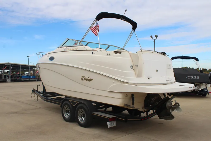 Slide: The Image of 2002 Rinker Fiesta Vee 250 boat on trailer, displayed outdoors with American flag. - 5