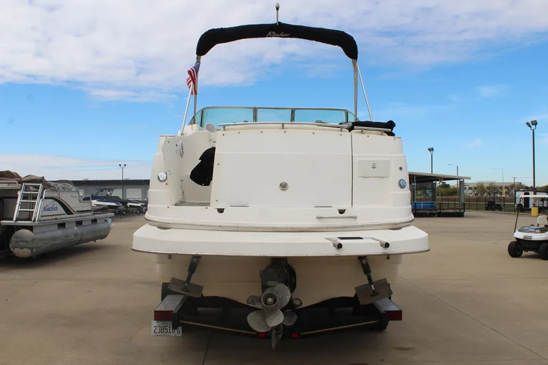 Slide: The Image of 2002 Rinker Fiesta Vee 250 boat on trailer, rear view, with American flag. - 6