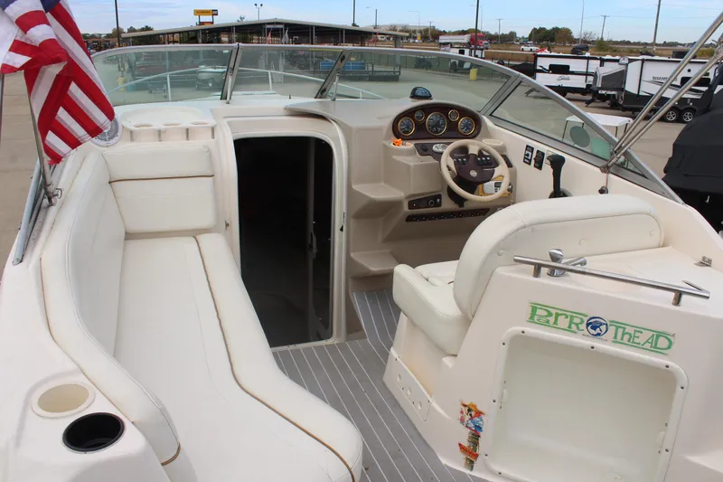 Slide: The Image of 2002 Rinker Fiesta Vee 250 boat interior with steering wheel and seating. - 9