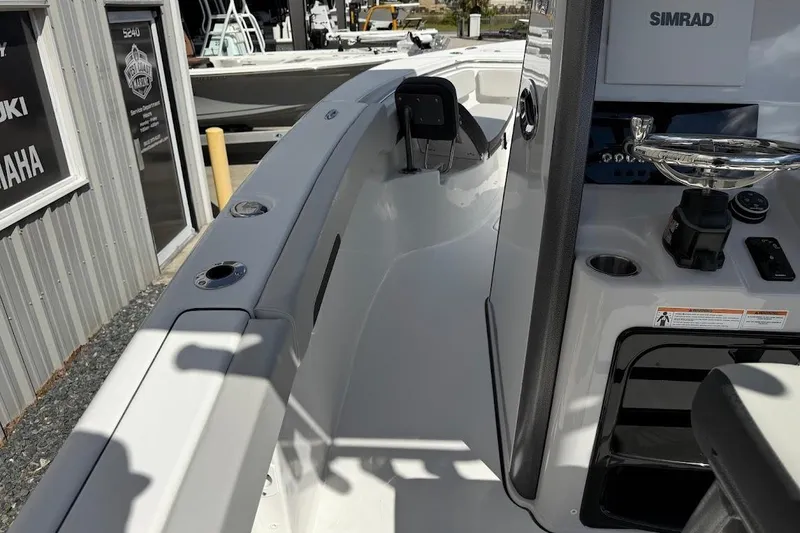 Slide: The Image of 2026 Sea Pro 242 Center Console boat interior with steering and control panel. - 14