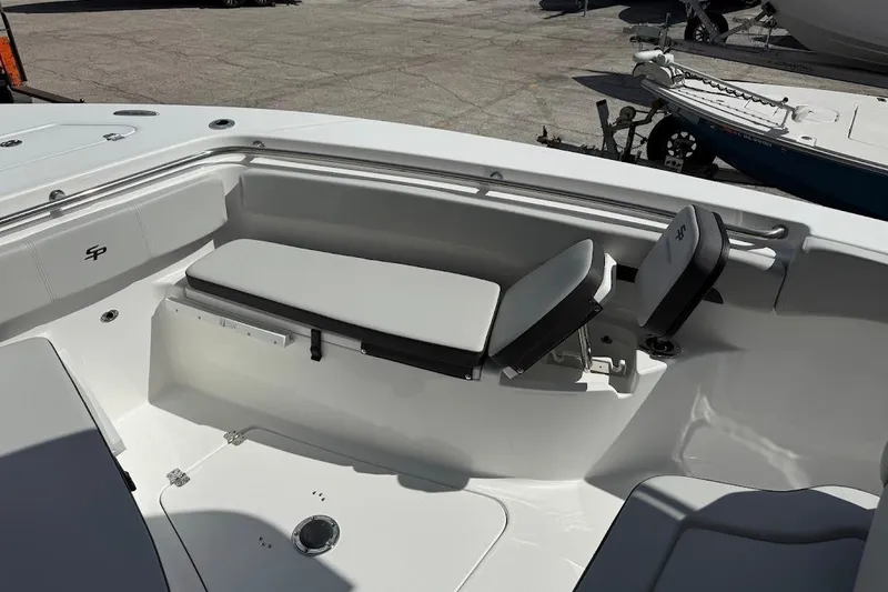 Slide: The Image of 2026 Sea Pro 242 Center Console boat interior with cushioned seating and sleek design. - 15