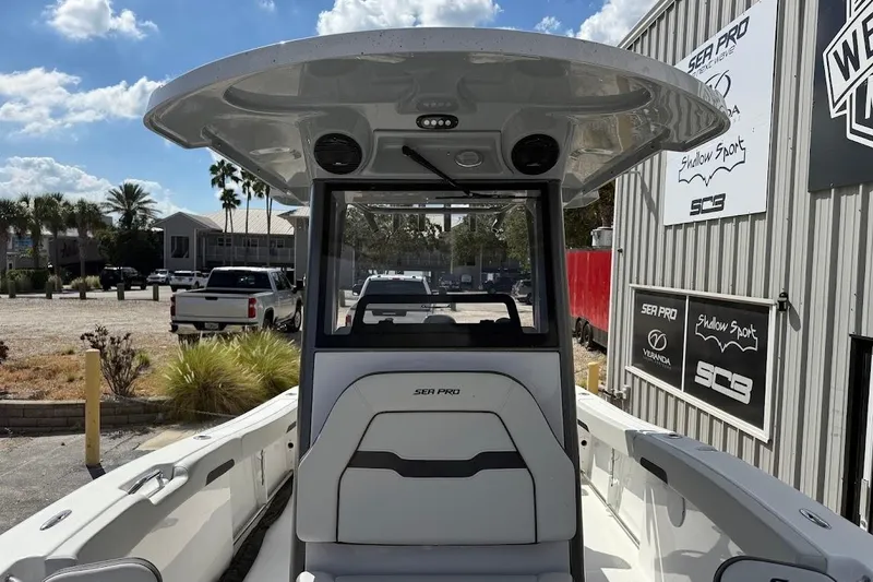 Slide: The Image of 2026 Sea Pro 242 Center Console boat at dealership, showcasing sleek design and spacious interior. - 17