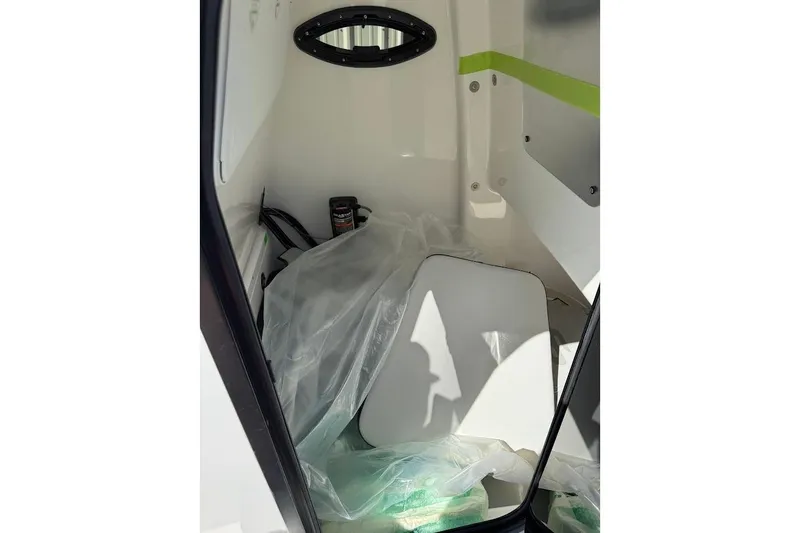 Slide: The Image of 2026 Sea Pro 242 Center Console interior with storage compartment and equipment. - 19